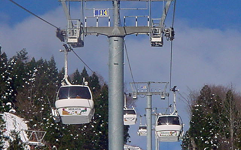 View of ski lift ascending a snowy mountain at Ojiro ski resort in Kansai, Hyōgo, Japan, suggesting winter sports activities.