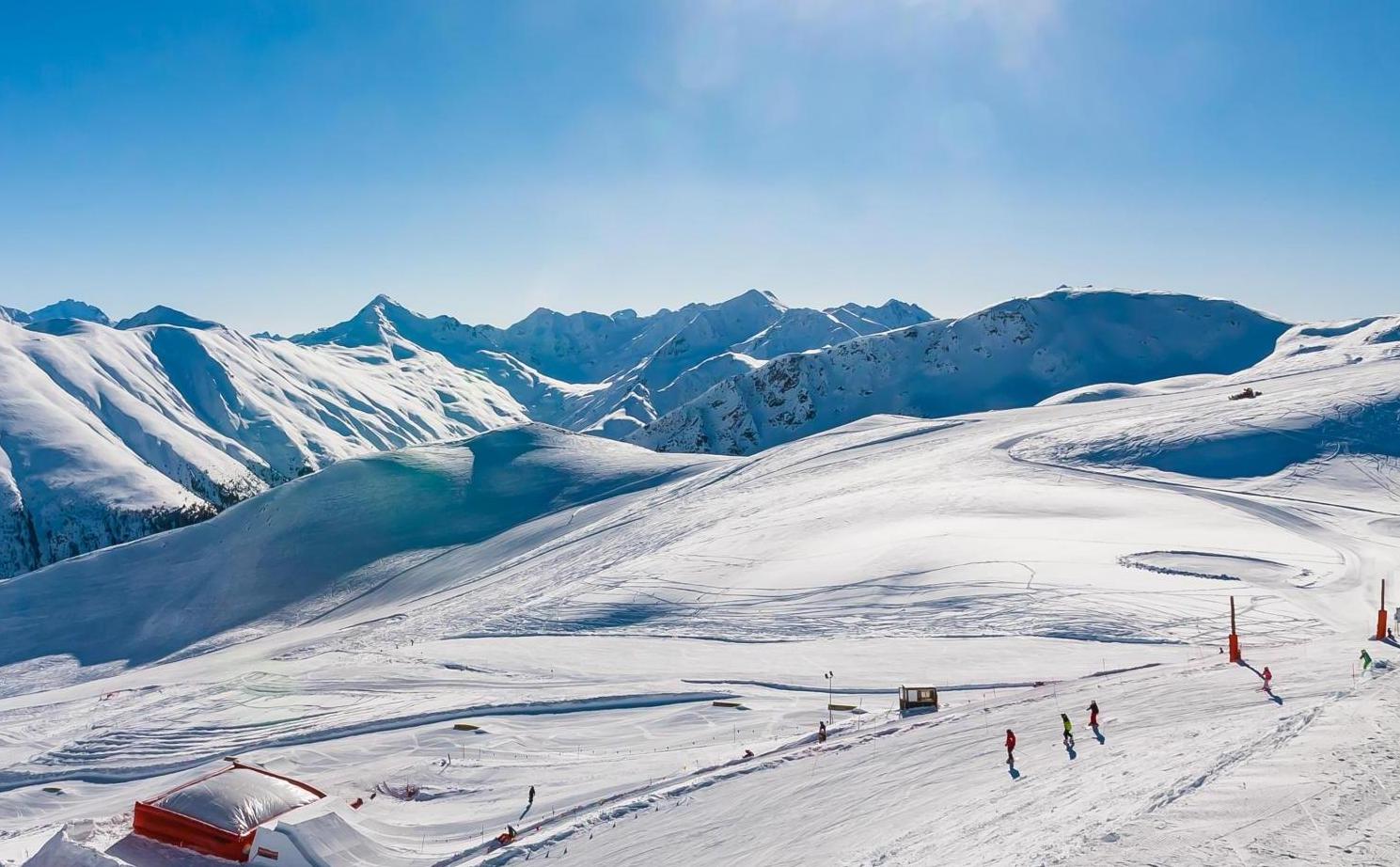 Livigno in Italy - a group of people skiing down a snow covered mountain.