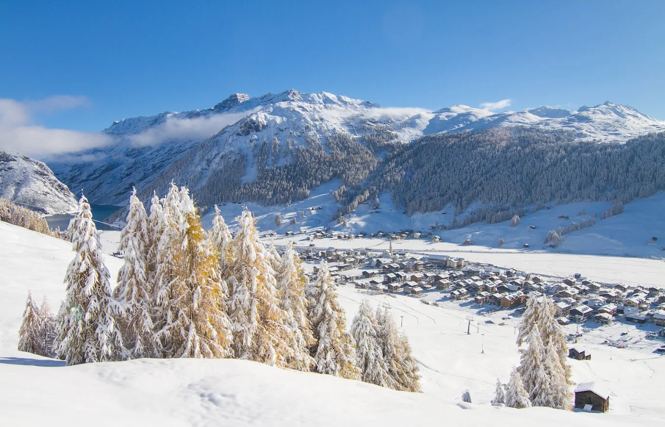 Livigno in Italy - a snow covered mountain with a small town in the background.