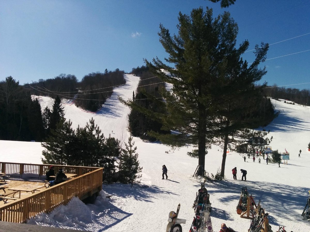 Antoine Mountain in Canada - a group of people skiing down a snowy slope.