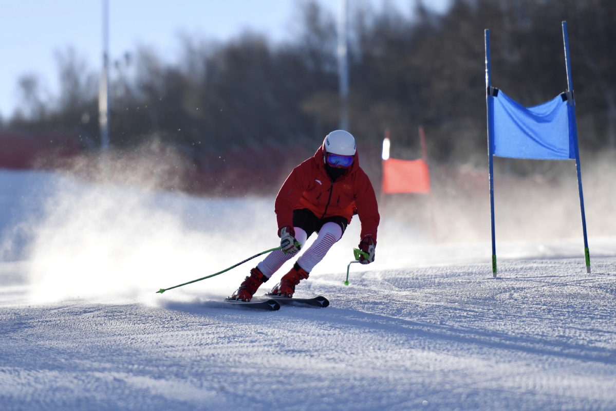 Changchengling in China - a person in a red jacket skiing down a hill.
