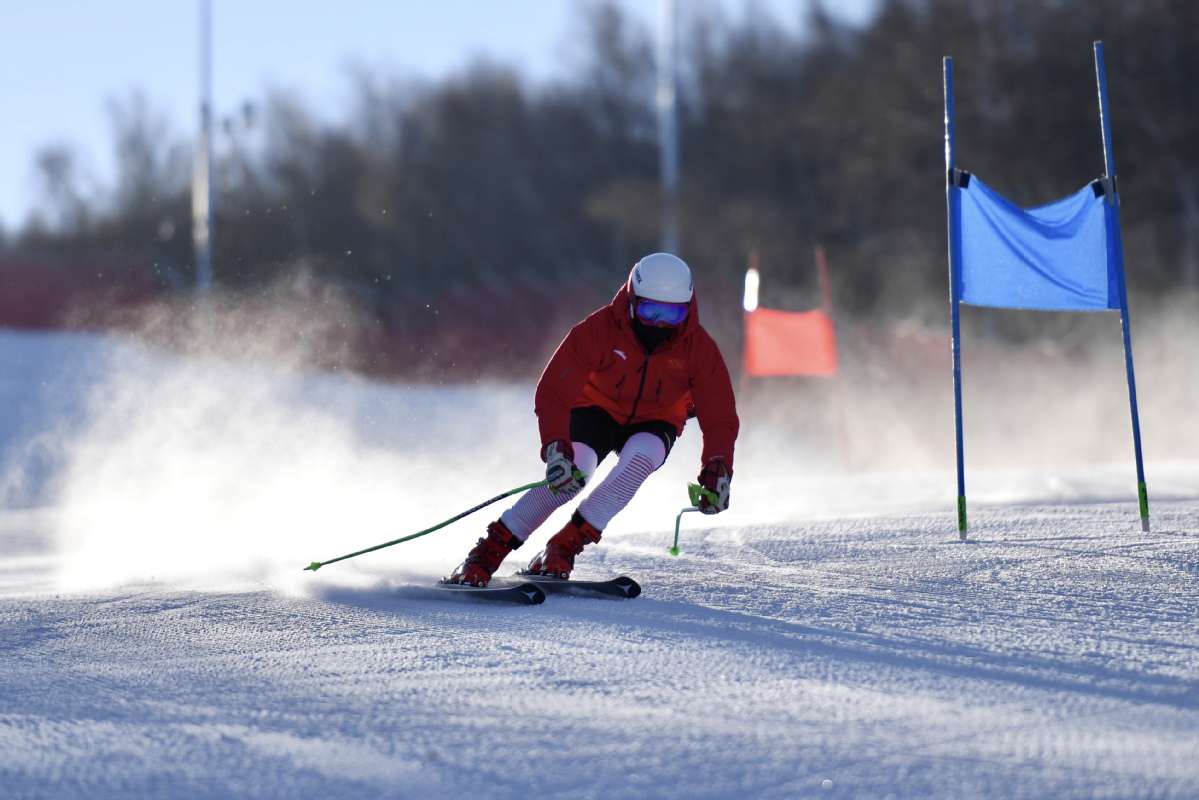 Changchengling in China - a person skiing down a hill on ski equipment.