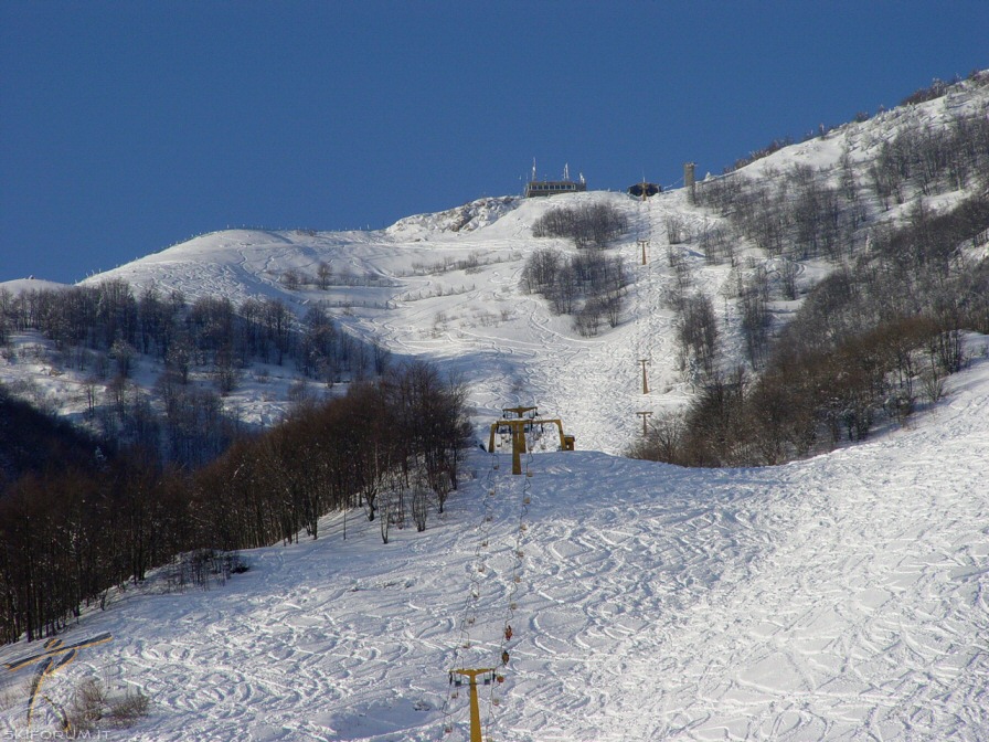 A picturesque image from the ski resort of Recoaro Mille in Vicenza Italy showing a ski lift rising above the snow-covered slopes supporting winter sports activities