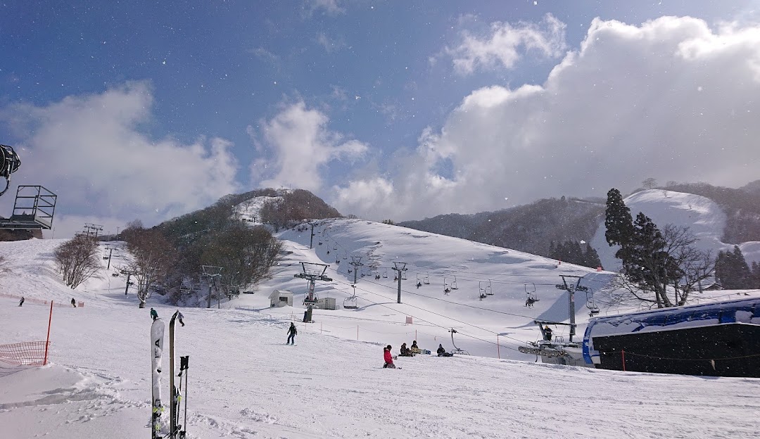 Winter scene at the Okuibuki ski resort in Kozuhara, Honshu, Japan; featuring snow-covered slopes perfect for winter sports, and a cozy chalet.