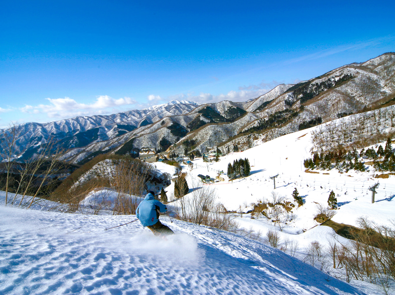 Okuibuki in Japan - a person riding a snowboard down a snowy slope.