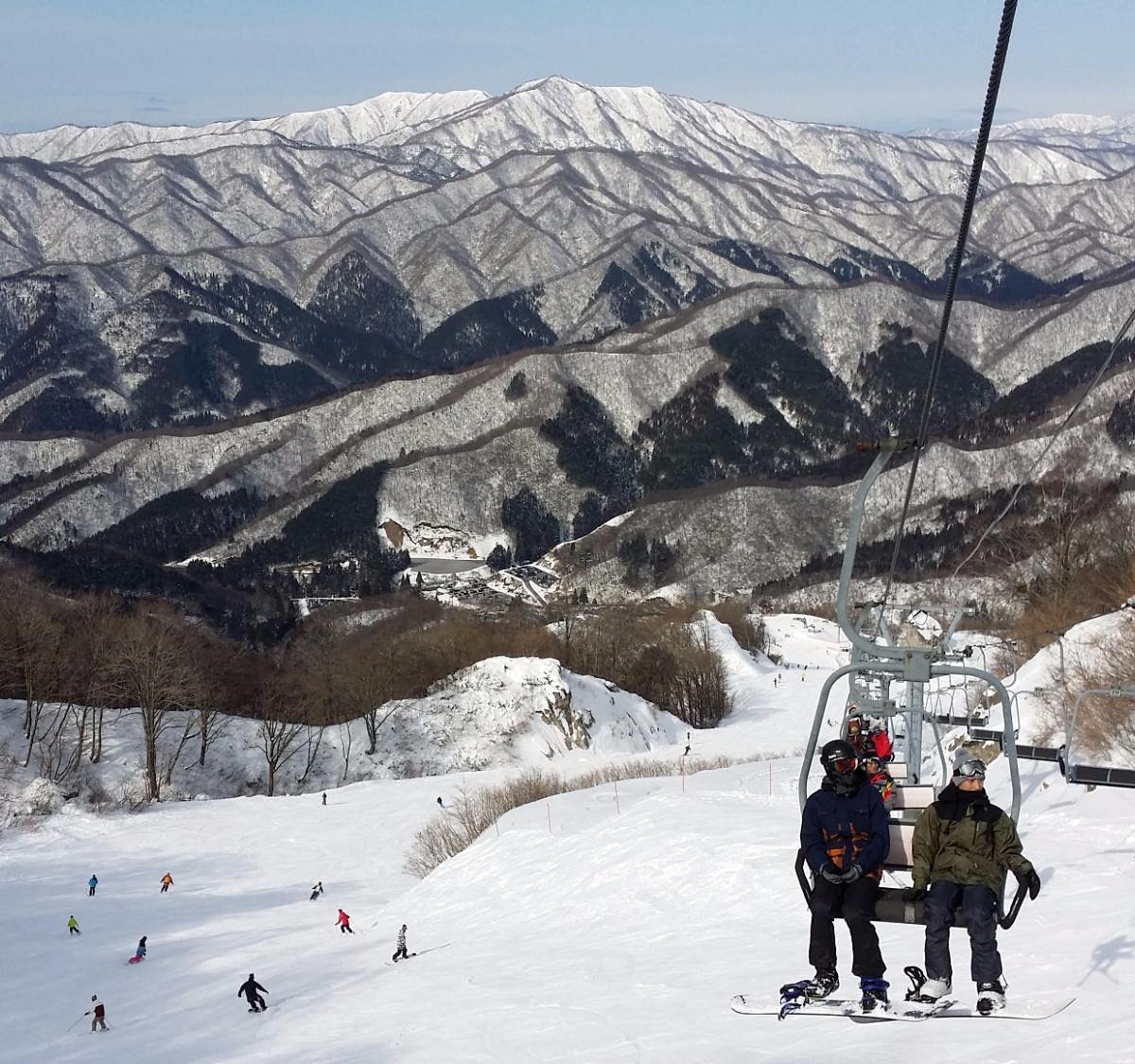 Okuibuki in Japan - a group of people skiing down a mountain.