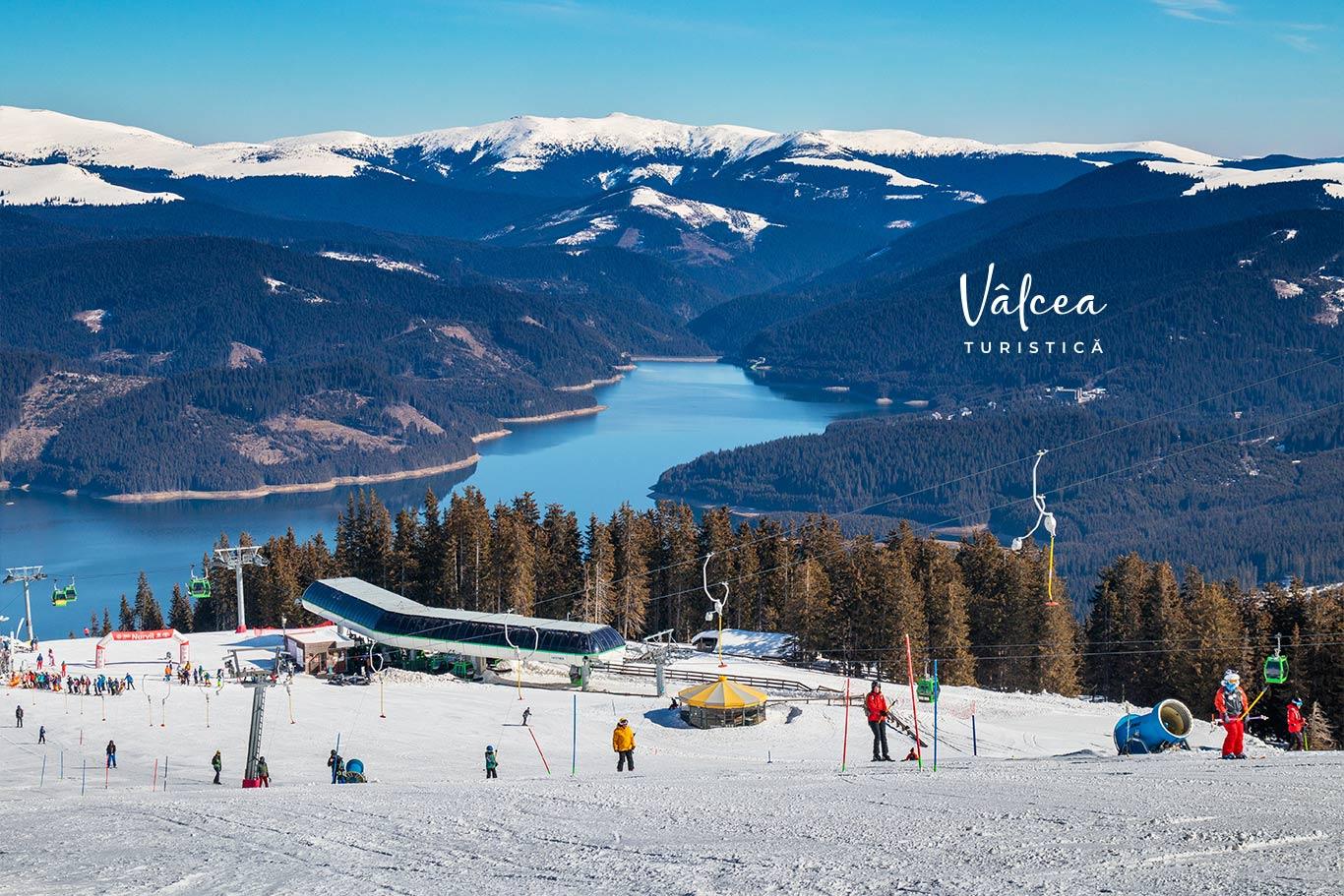 Transalpina – Vidra - Voineasa in Romania - a group of people skiing down a snowy slope.