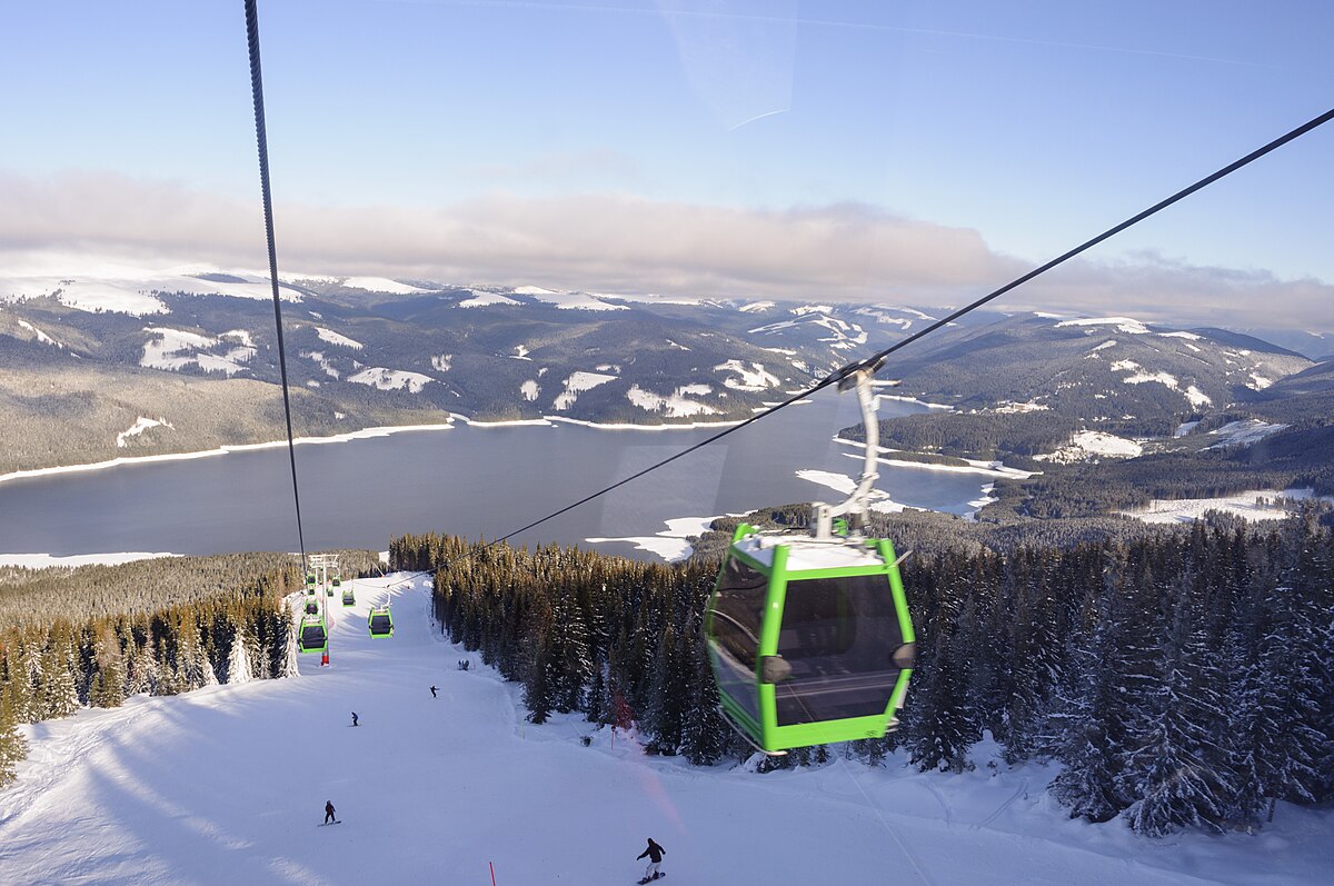 Transalpina – Vidra - Voineasa in Romania - a ski lift going up a snowy mountain.