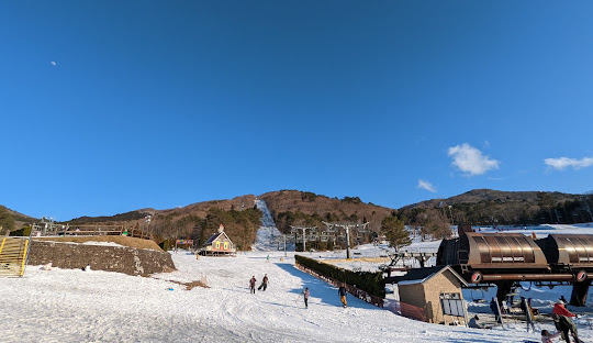 Image of the Utopia Saioto in Kitahiroshima, Japan. Winter sports enthusiasts are enjoying the pristine white snow at the ski resort, surrounded by stunning winter scenery.