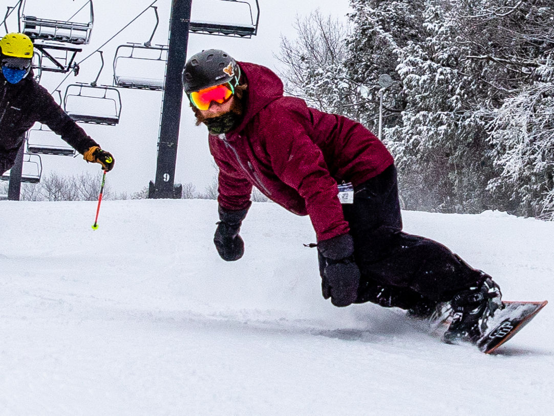 Crotched Mountain in USA - two people are skiing down a snowy hill.