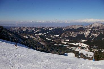 Image of the picturesque Tateyama Sanroku Raicho Valley Area in Japan featuring a charming chalet, a scenic ski resort and an enchanting winter sports scene.