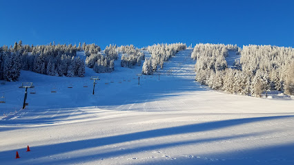 View of Loup Loup Ski Bowl in Okanogan, Washington showcasing the ski resort, a cozy chalet, and winter sports enthusiasts enjoying the stunning scenery.