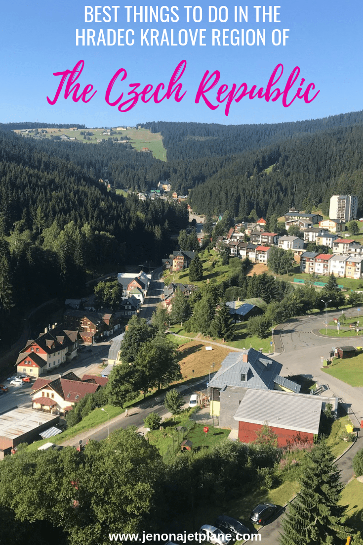 Ski center Říčky in Czech Republic - a view of a small town with trees and mountains in the background.