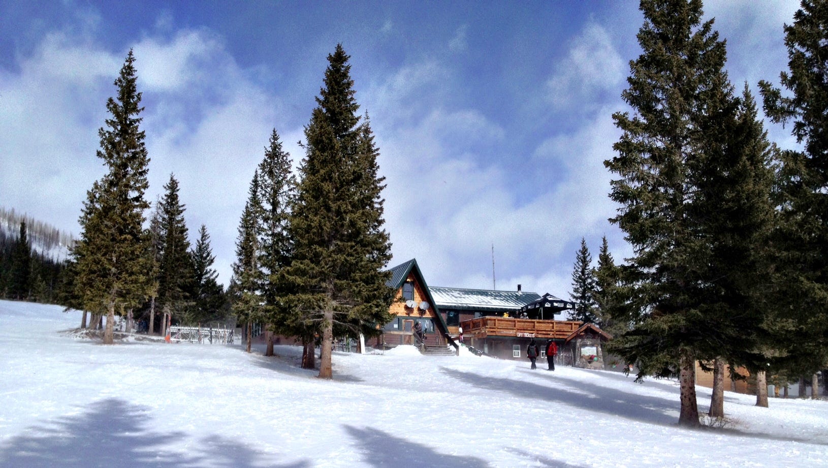 Teton Pass in USA - a snow covered ski slope with trees in the background.