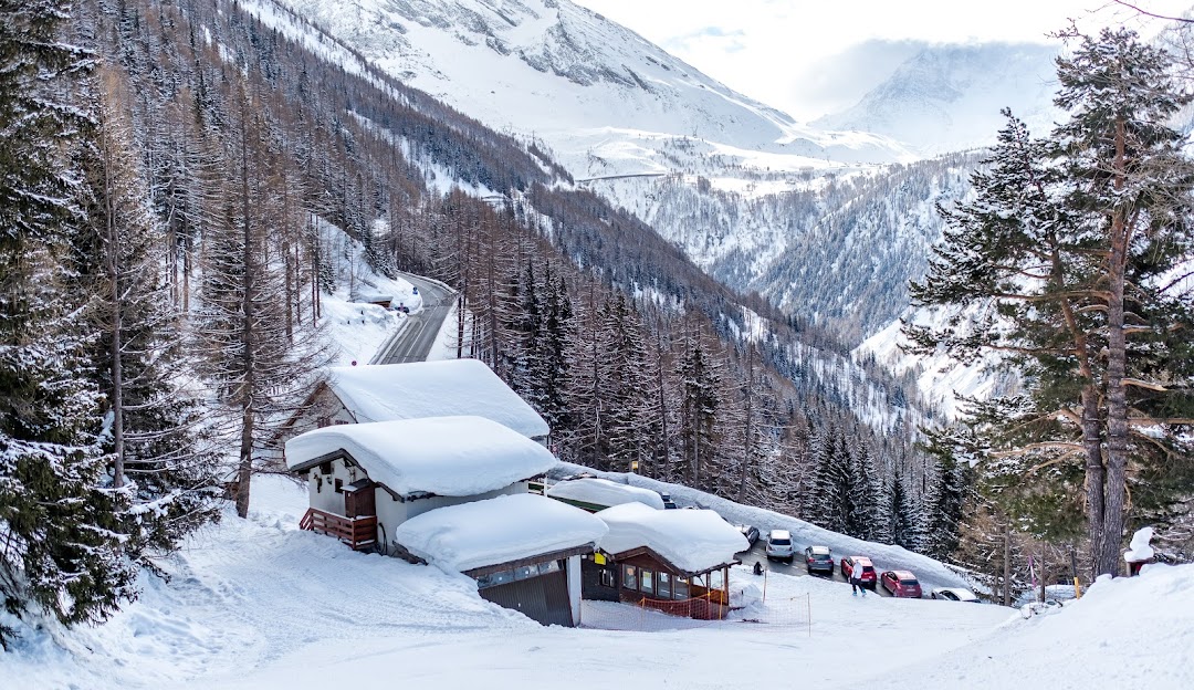 View of Rothwald ski resort in Switzerland, featuring a bustling winter sports scene. The image portrays a beautiful winter landscape, with a cosy mountain hut nestled amidst the scenic beauty.
