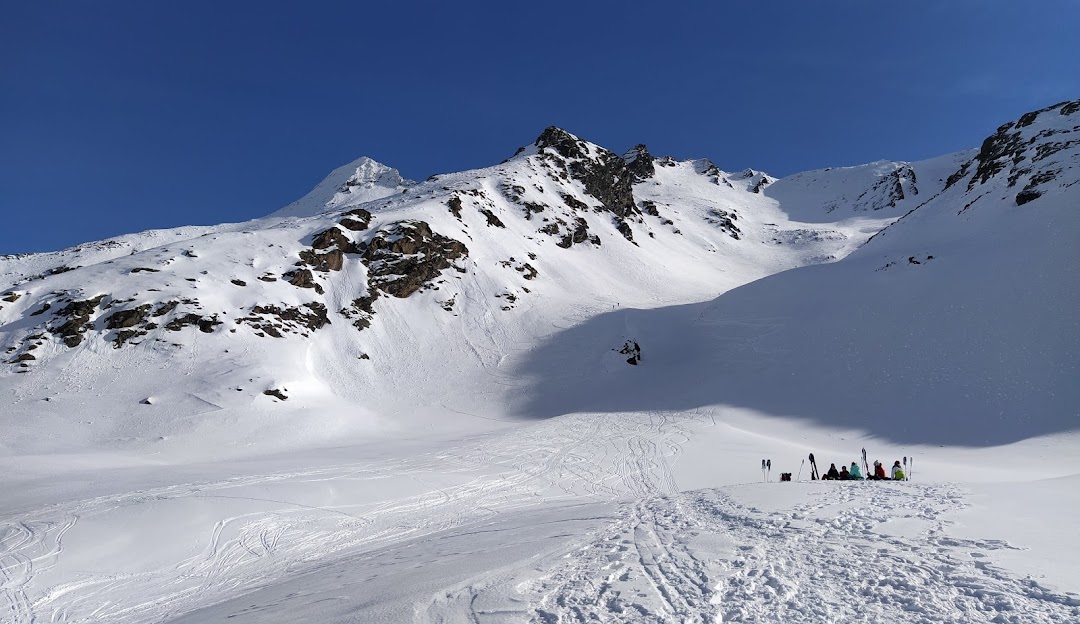 A skier enjoying a day out on the snow-covered slopes at the Rothwald ski resort in Switzerland with a picturesque backdrop of mountains.