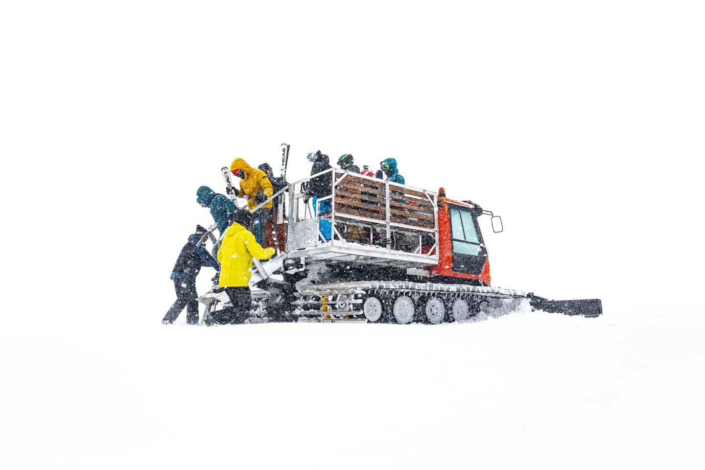 Bluewood in USA - two people standing in the snow next to a truck.