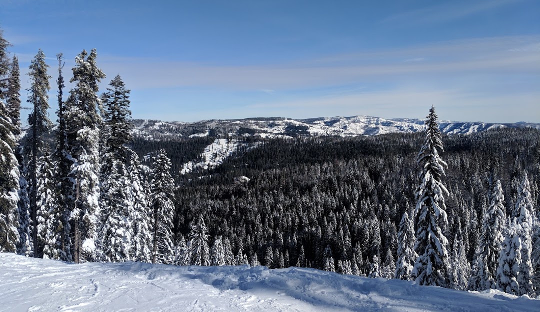 A skier enjoying a run at the Bluewood ski resort in Dayton, Washington State, USA. The winter sports scene beautifully encapsulates the snowy mountain scenery.