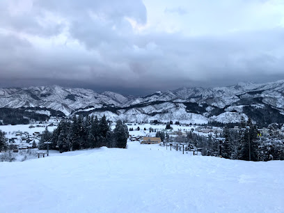 Scene from Suhara, Japan displaying a bustling ski resort amidst stunning winter landscape, with snow-covered slopes and a chalet subtly nestled against the scenic backdrop.