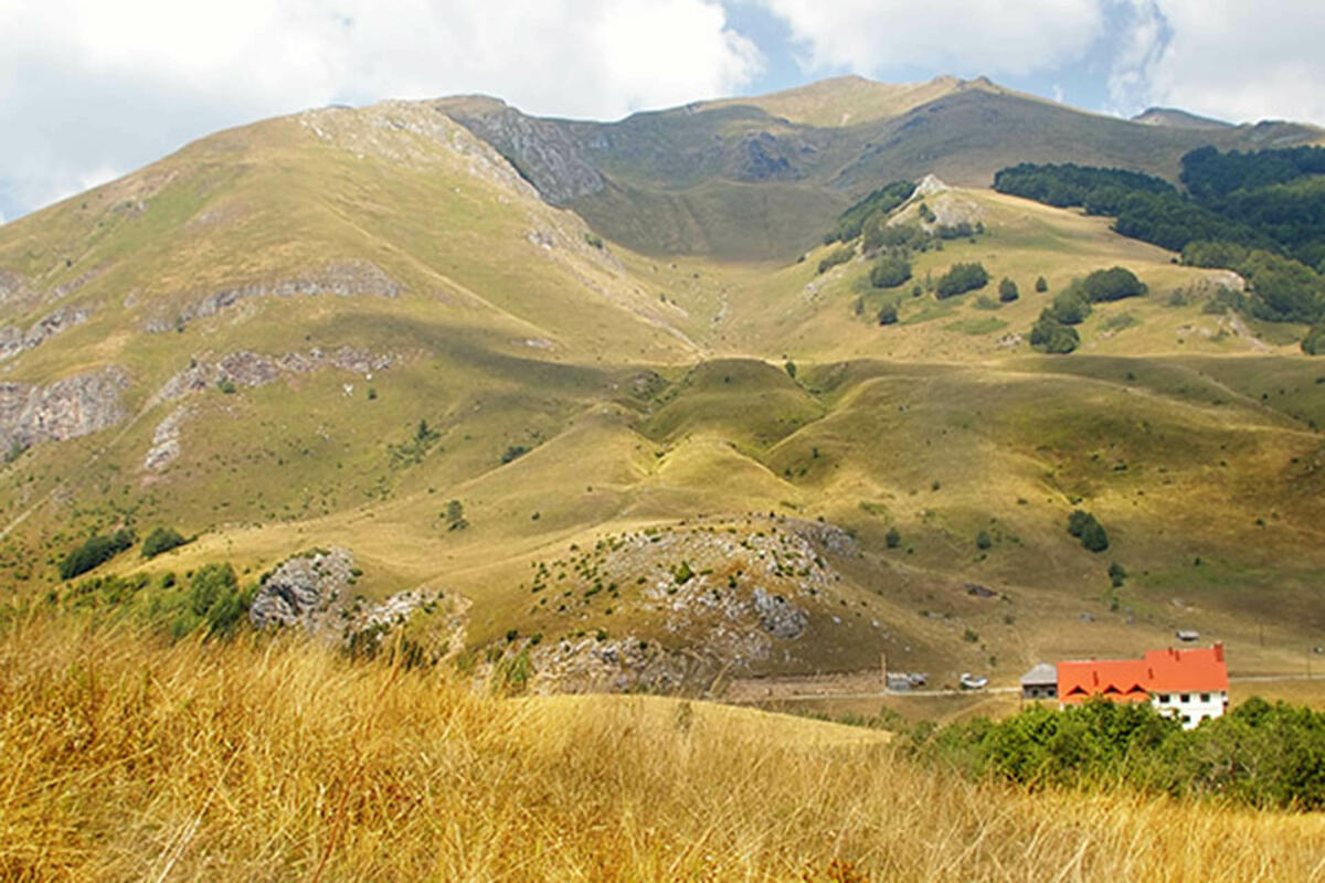 Ski centar Cmiljača in Montenegro - a hill with a red house in the middle.