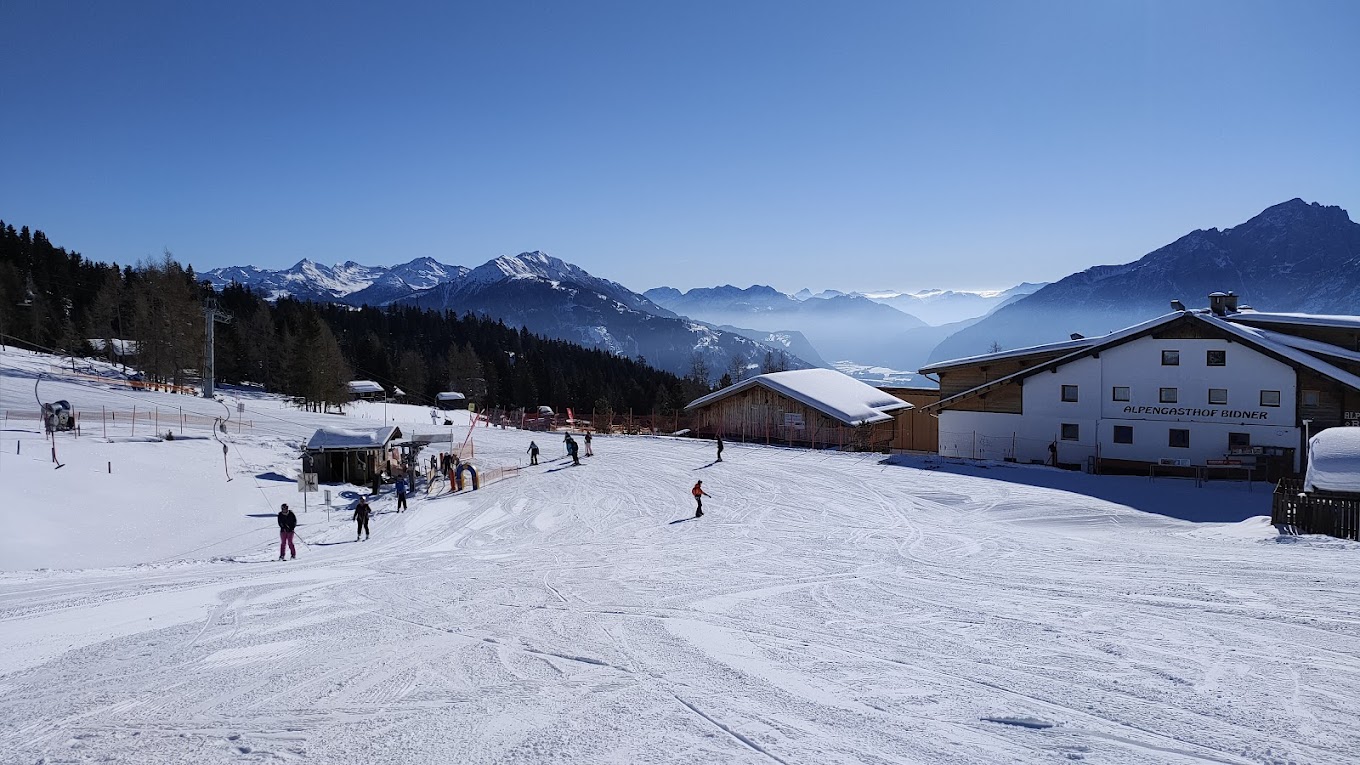 Zettersfeld Lienzer in Austria - a group of people skiing down a snow covered slope.