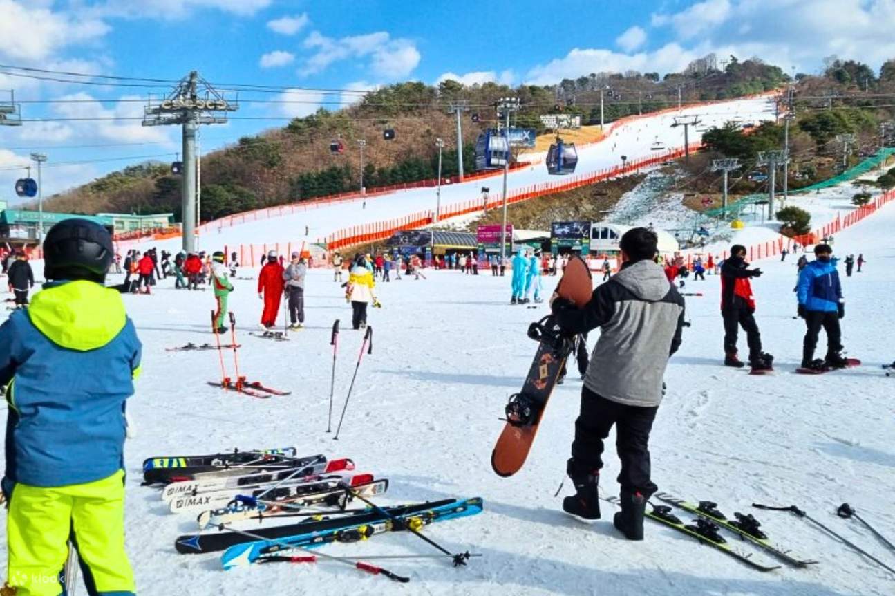 Vivaldi Park in South Korea - a group of people standing on top of a snow covered slope.