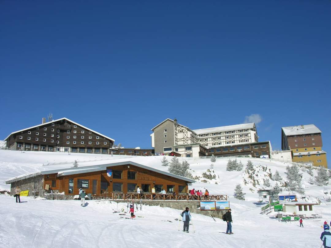 Kartalkaya in Turkey - a group of people skiing down a snow covered mountain.