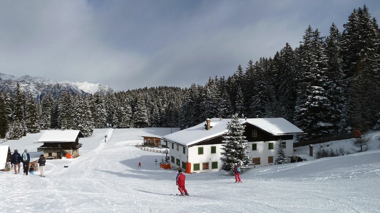 Vigiljoch – Lana in Italy - a group of people skiing down a snow covered slope.