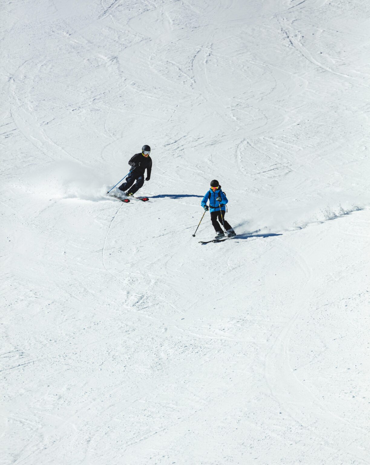 Skier gliding down a wintry slope at Vigiljoch – Lana a popular ski resort in South Tyrol Italy with a visible ski lift and group of skiers in the background.
