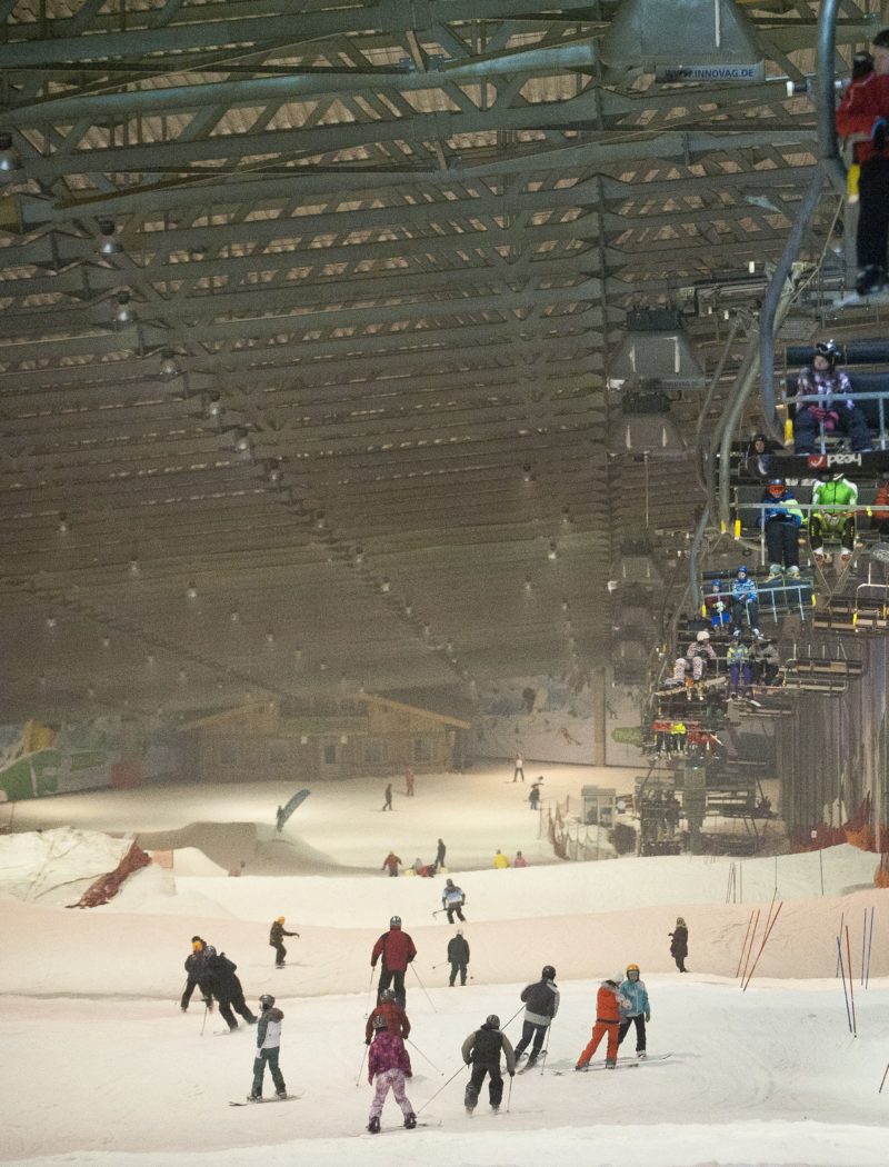 Snow Arena – Druskininkai in Lithuania - people are skiing on a ski lift in the snow.