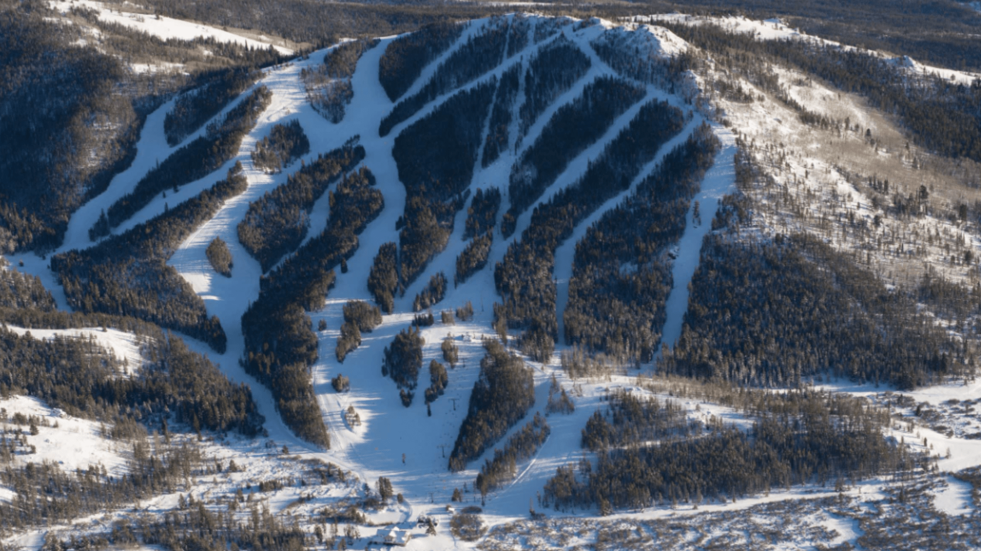 A snowy day at White Pine ski resort in Pinedale Wyoming showcasing snow-covered slopes with a ski lift on the mountainside exemplifying a typical winter sports scene.