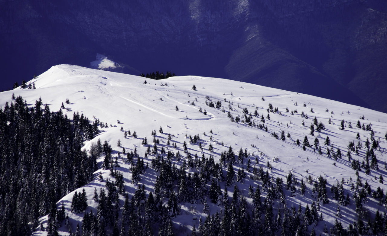 A winter sports scene at Monte Pora in Lombardy Italy showcasing snow-covered slopes a ski resort and a towering