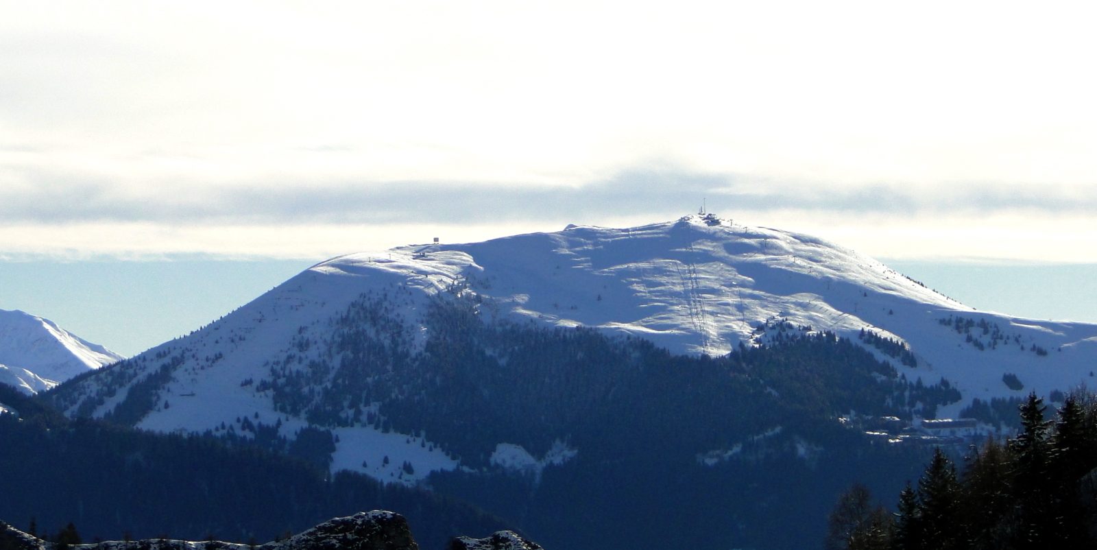 Monte Pora in Italy - the mountains are covered in snow and trees.
