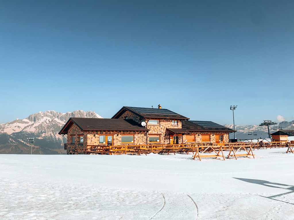 View of the Monte Pora ski resort in Lombardy Italy showing a bustling winter sports centre surrounded by the serenity of a picturesque winter scene.