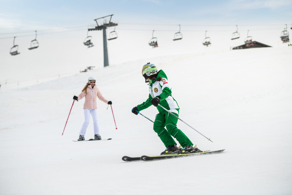 A skier enjoying the slope at Monte Pora ski resort in Lombardy Italy encapsulating a lively winter sports scene.