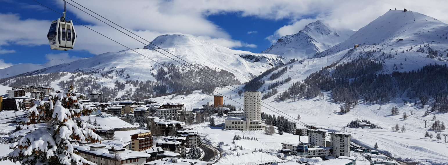 Via Lattea in Italy - a ski lift going up a snowy mountain.