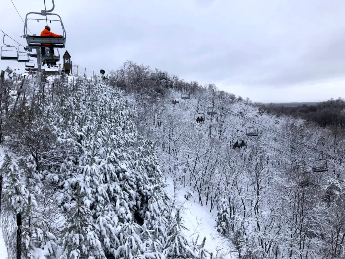 Caberfae Peaks in USA - a ski lift going up a snowy hill.
