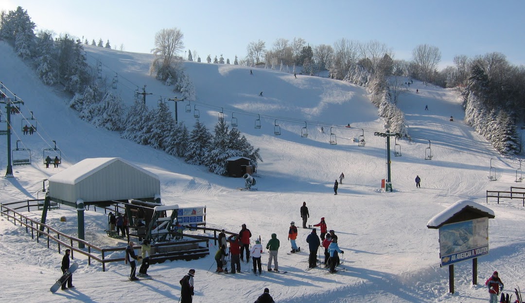Winter sports enthusiasts enjoy a day at Mt Kato Ski Resort in Mankato, Minnesota, complete with ski lifts and breathtaking winter scenery.