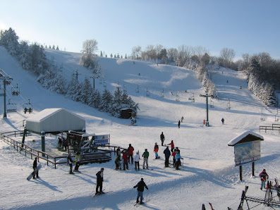 Ski resort scene at Mt Kato in Mankato, Minnesota featuring impressive winter scenery and ski lifts, capturing the vibrant energy of a bustling winter sports center.