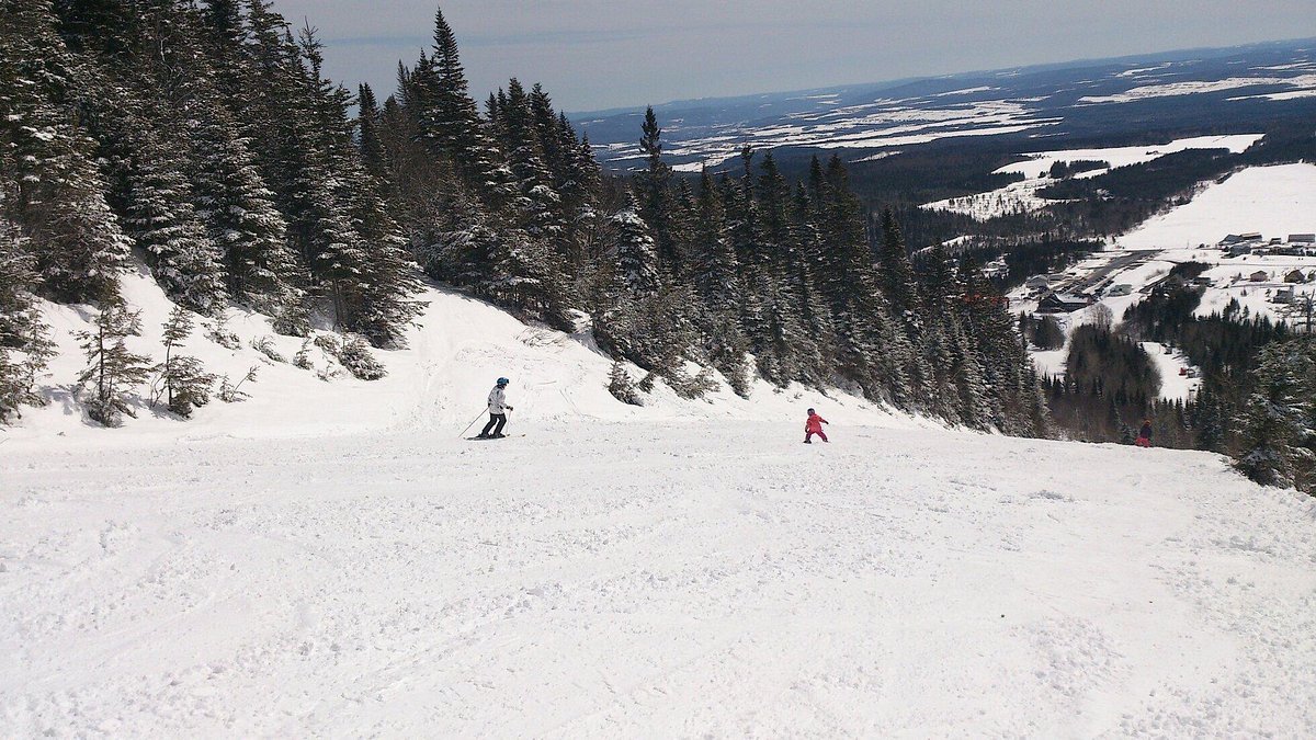 Val d'Irène in Canada - a group of people skiing down a snowy slope.