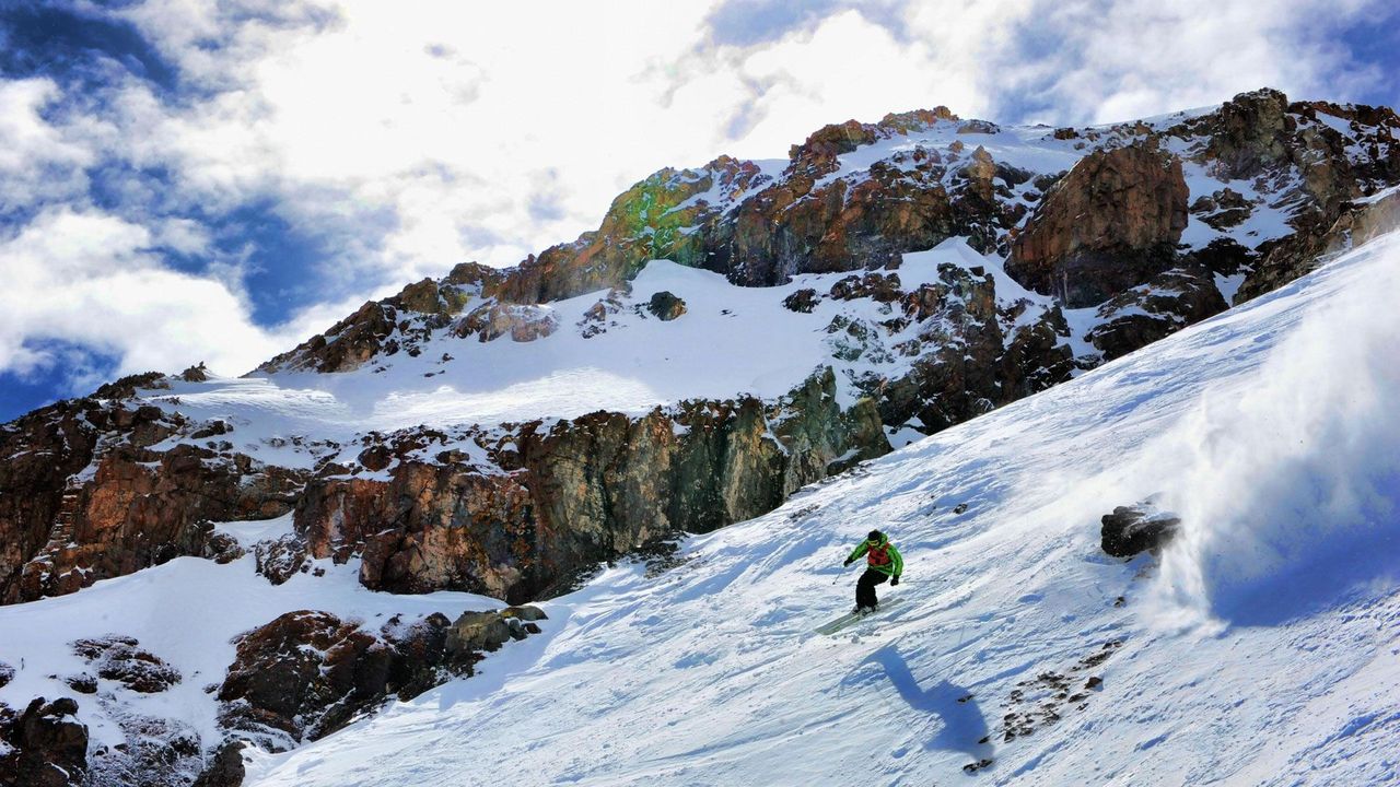 Club Andino in Chile - a person is skiing down a snowy mountain.