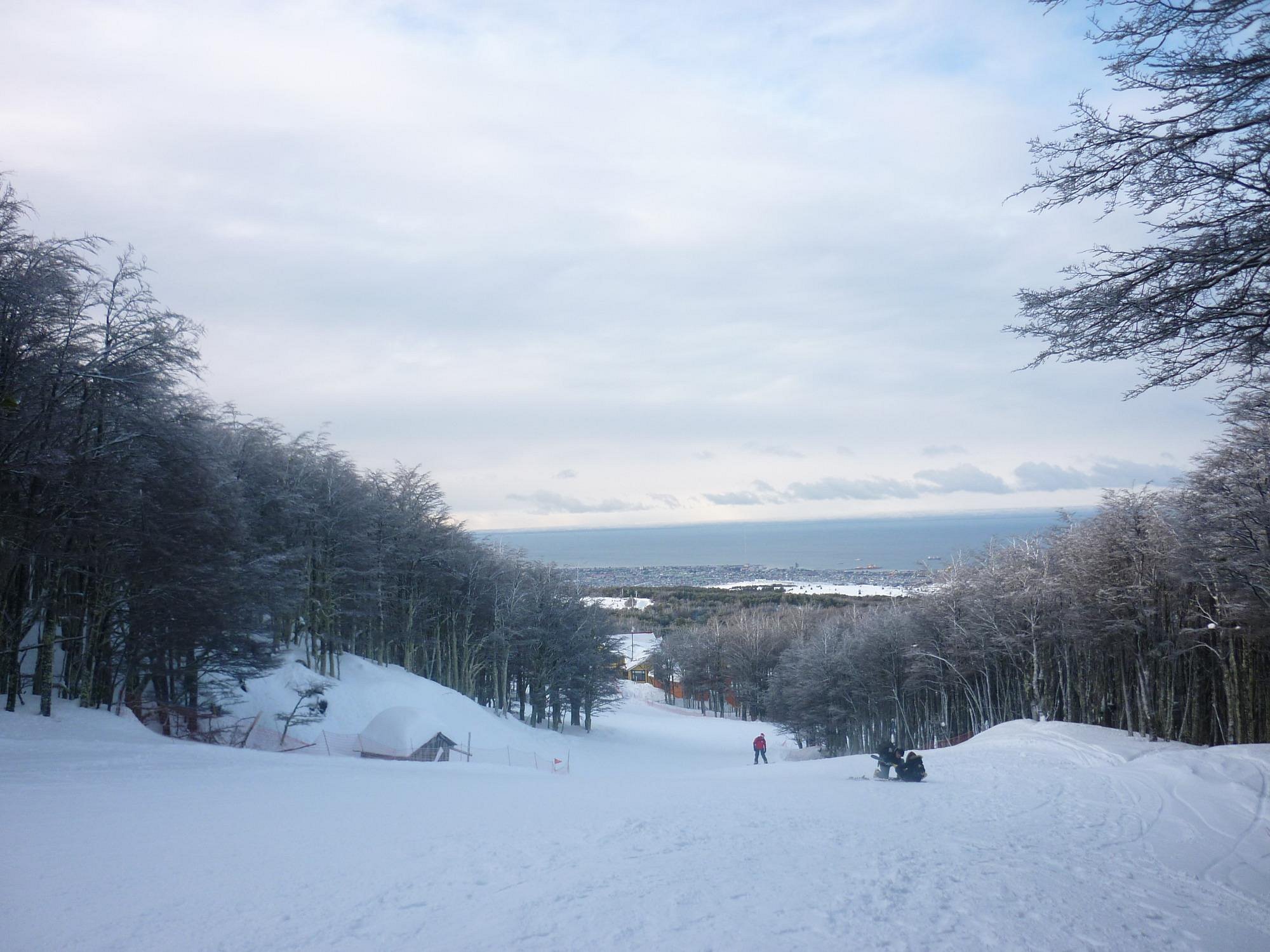Winter sports scene at Club Andino in Punta Arenas, Chile, featuring a chalet and ski resort amidst breathtaking winter scenery.