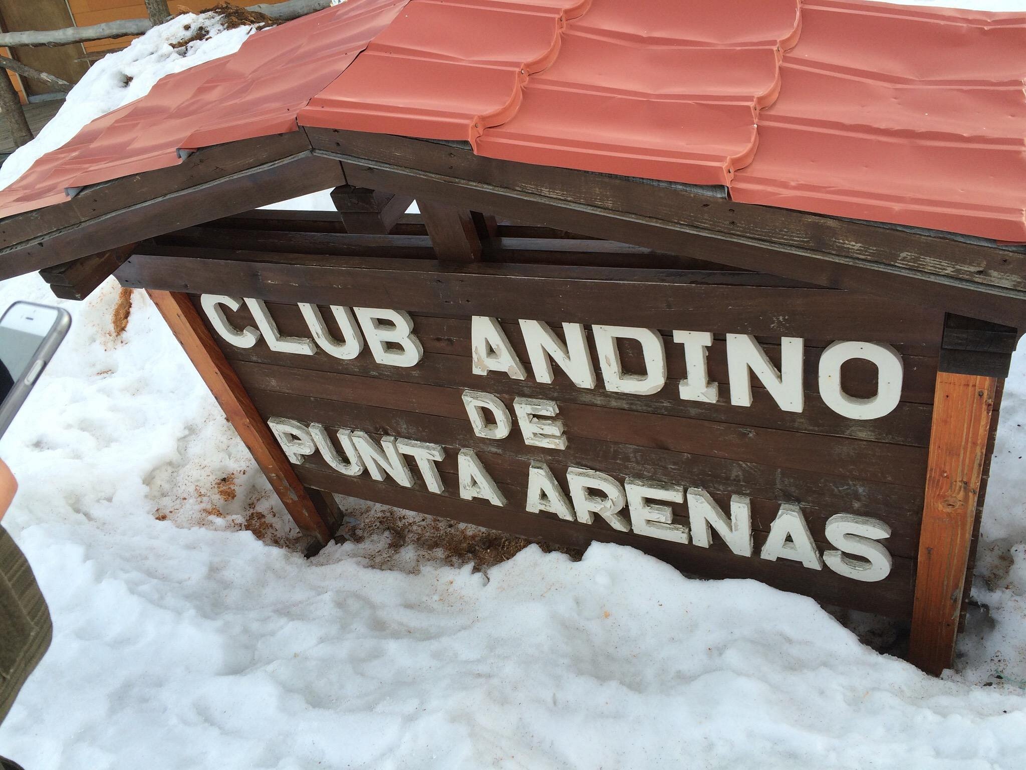 View of Club Andino winter sports centre in Punta Arenas, Chile, featuring a ski resort, lodge, chalet, amid a scenic winter landscape.