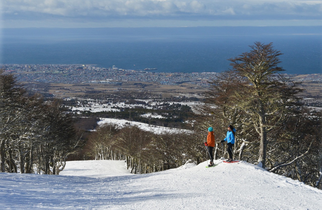 Club Andino in Chile - two people standing on top of a snow covered hill.