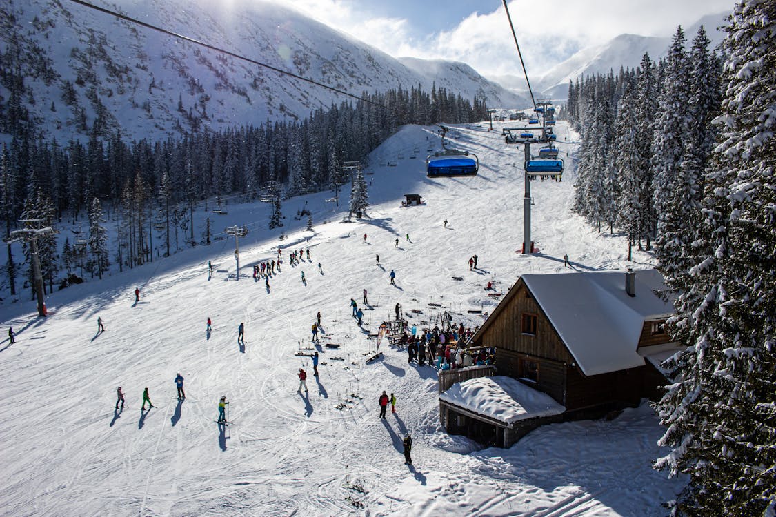 Roháče – Spálená in Slovakia - a group of people skiing down a snowy slope.