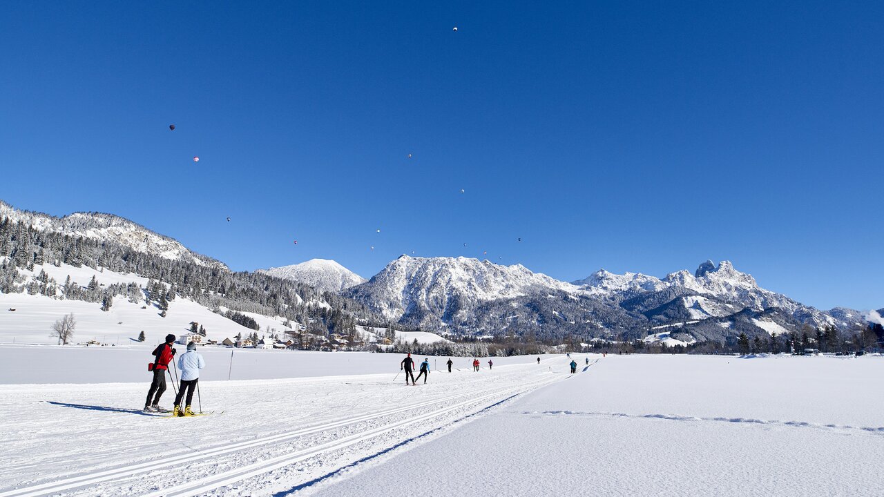Krinnenalpe in Austria - a group of people skiing down a snow covered slope.