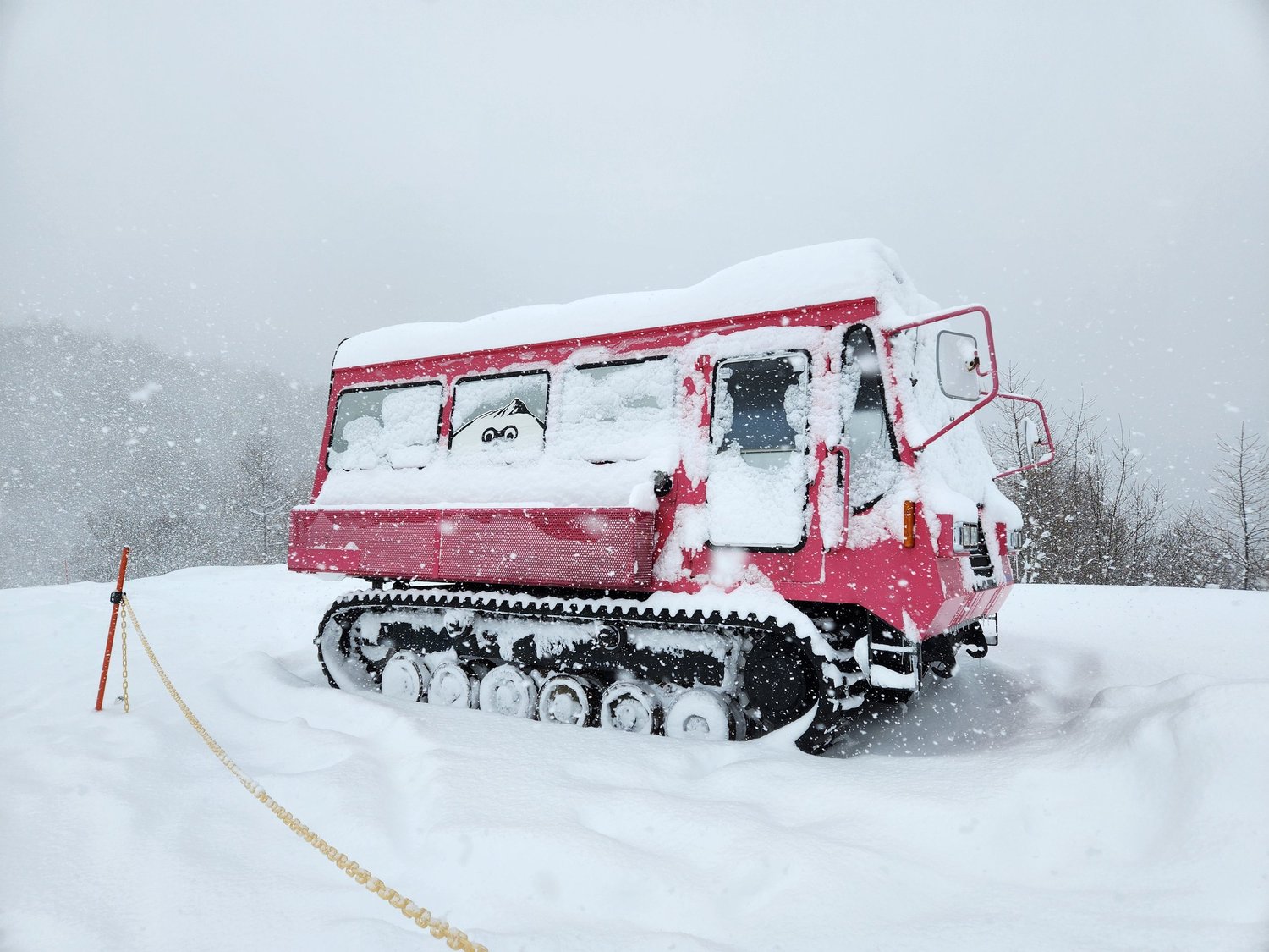 Nekoma in Japan - a red and white truck covered in snow.