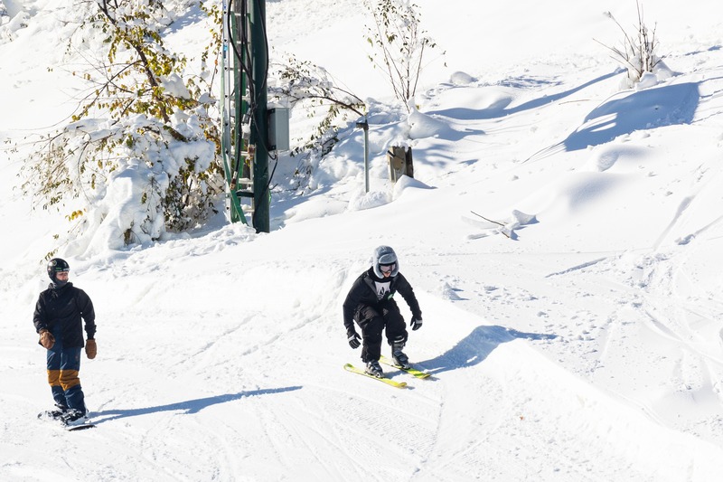 A snowboarder navigating the snowy terrain during winter at Bittersweet Otsego Michigan.