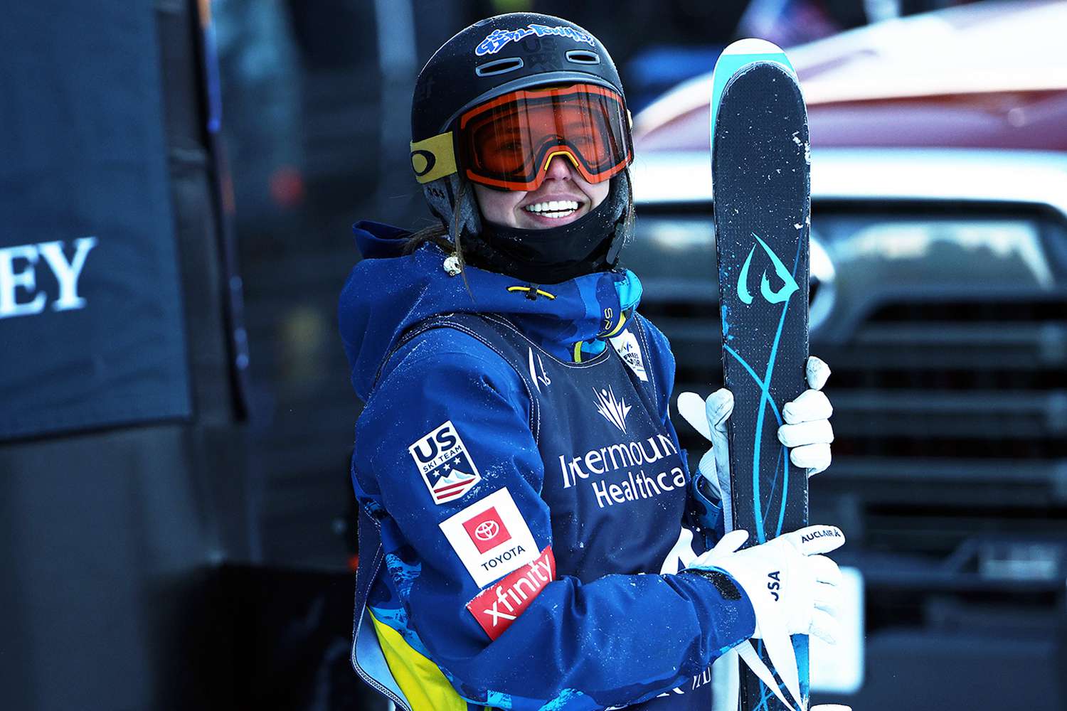 Bittersweet in USA - a man in a blue jacket holding a snowboard.