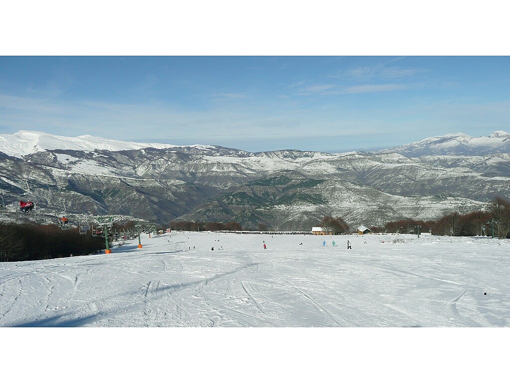 Prato Selva in Italy - a snow covered ski slope with mountains in the background.